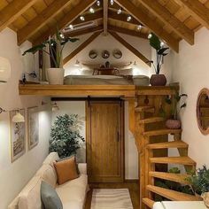 a living room filled with furniture next to a wooden staircase