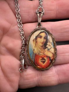 In good vintage condition!  Wear on finish. Handmade Vintage Necklace In Antique Silver, Retro Handmade Oval Jewelry, Vintage Antique Silver Necklace With Round Pendant, Retro Oval Necklace For Gift, Vintage Virgin Mary, Vintage Souvenir, Vintage Lettering, Virgin Mary, Crystal Necklace