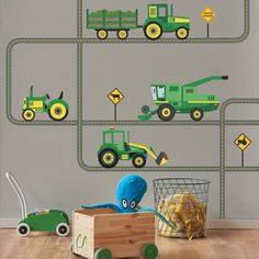 there is a toy truck and tractor on the road wall decals in this children's room