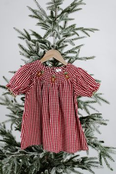 Smocked Gingerbread Dress Add a vintage feel this Christmas with the new smocked dress with a touch of gingerbread details. It's easy to get into the holiday spirit with this one! Size: 12-18, 2, 3, 4, 5/6, 6/7, /8 Contents: 100% Cotton Colors: red & cream Gingerbread Dress, Sweet Grace Candle, Puff Sleeve Sweater, Blue Plaid Shirt, Footie Pajama, Dressy Dresses, Curvy Dress, Smocked Dress, Faux Leather Pants