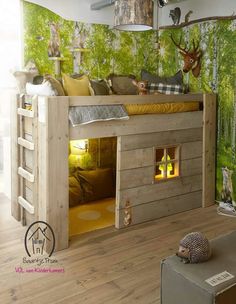 a bunk bed with deer head and trees on the wall in a child's bedroom