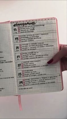 a person holding up a notebook with numbers on it