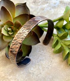 "This Hammered copper cuff is sturdy enough to look good on men but also looks great on women either by itself or paired with other bracelets. The hammered copper cuff is created from 14g quality copper that has been hammered into the pattern you see here and then antiqued to give it an aged look. An occasional wipe with a polishing cloth is all you'll need to keep this hammered copper cuff looking great.  Many people believe there are holistic and spiritual benefits to wearing copper. Copper symbolizes love and balance, and was used to heal and protect during ancient times. Many claim that wearing copper balances both the spirit and body. Your hammered copper cuff comes in three sizes. 6\", 7\", and 8\".  NOTE: Since these are handmade and individually hammered, your cuff may not look exa Adjustable Hammered Copper Cuff Bracelet, 7th Wedding Anniversary, Copper Cuff Bracelet, Wire Wrapped Bracelet, Copper Cuff, Hammered Copper, Wedding Anniversary Gifts, Silver Hoop Earrings, Copper Wire