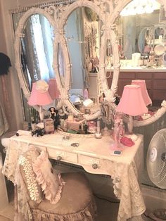 a dressing table with a mirror, stool and lamp