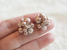 "Original Design by Glamorous Bijoux© Ultra lovely statement bridal stud earrings feature intricate modern vintage inspired petite pearl clusters as the dramatic focal point, consisting of lots of beautiful yet sparkly elements. Delicately handmade with champagne (powder almond) Swarovski pearls, Swarovski crystals, and silver plated rhinestone balls to create a retro glamour style. Carefully attached onto silver plated posts on the back. Measurements: Each cluster measures approximately 5/8\" a Elegant Cluster Bridal Earrings For Wedding, Silver Cluster Earrings For Wedding, Cluster Bridal Earrings For Wedding, Statement Bridal Jewelry, Stud Wedding Earrings, Bridal Earrings Studs, Bridal Earrings Pearl, Pearl Cluster, Earrings Pearl