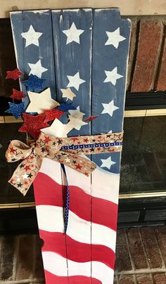 an american flag made out of wooden planks and tied with a bow on top