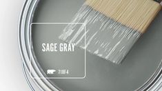 a paint can with a brush in it and the words sage gray painted on it