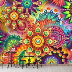 an artistic wall mural with bright colors and flowers on the walls, in front of a table