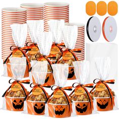 an assortment of halloween treat bags with orange and white striped paper plates in the background