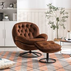 a brown chair and ottoman in a living room with a potted plant on the floor