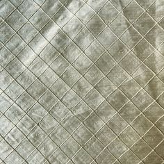 an image of a bed that is made out of silver sheets and blankets on top of each other