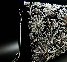 "Stunning heirloom quality luxury designer evening bag, exquisitely hand embroidered in an ornate floral pattern with antique silver colored metallic threads and embellished with genuine semi precious stones, to create an opulent 3D effect. This intricately and extravagantly jeweled masterpiece becomes a spectacular focal point to any outfit. It adds instant glamour and elegance. The purse glitters and glows with a fascinating light. Hand embroidered by the most skilled master artisans in the za Elegant Silver Embroidered Bags, Designer Silver Rectangular Clutch, Elegant Rectangular Evening Bag For Festivals, Elegant Embroidered Ceremonial Bags, Silver Hand Embellished Evening Bag For Formal Occasions, Traditional Clutch Evening Bag With Intricate Embroidery, Designer Silver Clutch As A Gift, Luxury Evening Bag With Intricate Embroidery, Luxury Evening Bag With Intricate Embroidery For Formal Events