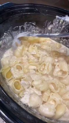 the pasta is being cooked in the crock pot with water coming out of it