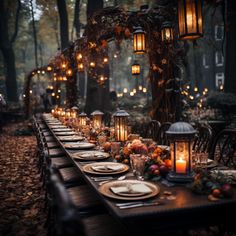 an outdoor dinner table set up with candles and place settings in the middle of it