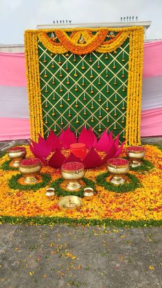 a decorated stage with candles and flowers on the ground