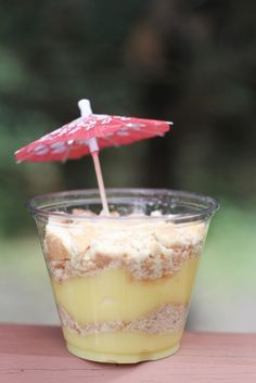 a dessert in a cup with an umbrella sticking out of it