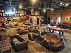 an old car is parked in front of a pool table