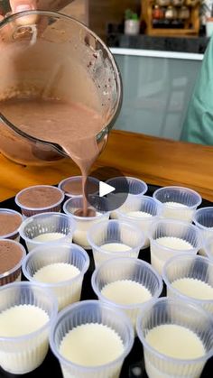 cupcake batter being poured into muffin cups on top of a baking tray,