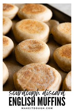 some english muffins are on a baking sheet