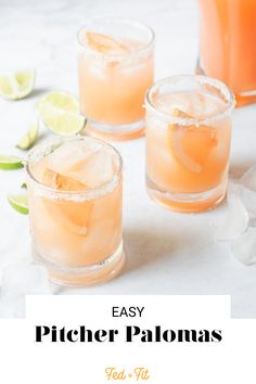 three glasses filled with peach lemonade and limes on top of a white table