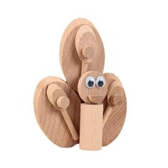 a wooden toy with eyes on it