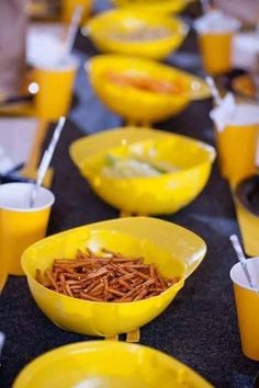 yellow bowls filled with food sitting on top of a table