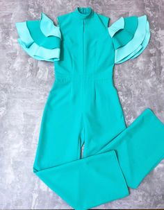 Mint and turquoise pageant jumpsuit/ Cold Shoulders jumpsuit/ Ruffles Turquoise romper/ Girls Interview outfit/ Pageant casual wear This beautiful romper is made from high quality polyester fabric. This material is stretchy. The top has zipper back. It is easy to care and comfortable to wear. It has a ruffles sleeves. The jumpsuit is perfect for interview competition and other pageant events. It is absolutely stunning on! Materials Polyester fabric Colors and sizes The jumpsuit can be made in an Green Sleeveless Ruffled Jumpsuits And Rompers, Light Blue Jumpsuits And Rompers For Spring Party, Green Fitted Jumpsuit With Ruffles, Fitted Green Jumpsuits And Rompers With Ruffles, Elegant Light Blue Jumpsuits And Rompers For Party, Green Overall Jumpsuits And Rompers For Party, Fitted Light Blue Jumpsuit For Party, Fitted Light Blue Party Jumpsuit And Romper, Pageant Jumpsuit