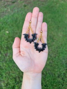 These black polymer clay bats are exquisite. They are perfect for this spooky season. These earrings are extremely lightweight and very durable. They come in two variations for finish (shine and no shine) and three variations in material (stainless steel gold stud, sterling silver hook and stainless steel hook). These Halloween bats are perfect for any fall occasion! Spooky Black Drop Earrings, Handmade Spooky Black Earrings, Handmade Black Vampire Earrings, Clay Bat, Halloween Clay Earrings, Clay Earrings Black, Spooky Earrings, Saturn Earrings, Ashley Brown