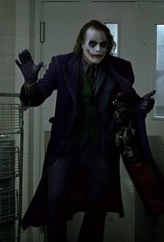 a man dressed as the joker in a hallway