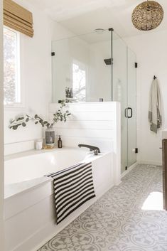 a white bathroom with black and white decor