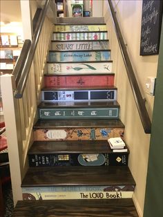 there is a stair case with books on it