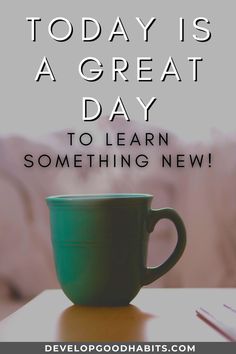 a green coffee cup sitting on top of a table with the words today is a great day to learn something new