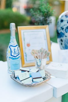 there is a bottle of wine and some chocolates on the table with other items