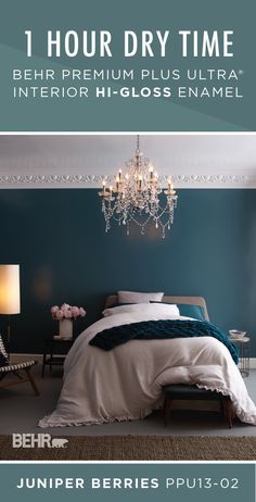 a bed room with a neatly made bed and a chandelier