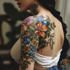 a woman with flowers on her back and shoulder