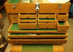 an open wooden drawer with drawers on it