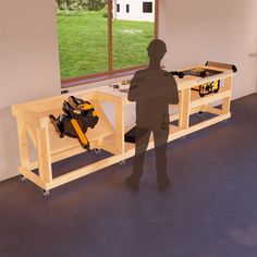 a man standing in front of a workbench