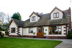 a white house with brown trim and windows