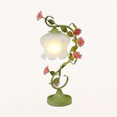 This is a traditional floor lamp with a white/green shade made of frosted glass. It measures 12 to 13 inches in size, 21 inches in length, and 12 inches in width. The shade is bell-shaped and the fixture height is 21 to 25 inches. This lamp requires one bulb (not included) with a base of E26/E27. It is compatible with LED, incandescent, and fluorescent bulbs. The voltage is 220V-240V 110V-120V.Size: 12 to 13 Inch Fixture Width: 12" Fixture Height: 21 to 25 Inch Bulb Included: No Number of Lights Glass Table Living Room, Traditional Floor Lamps, Luxury Lamps, Rose Decor, Ceramic Light, Pink Ceramic, Bedside Lighting, Table Lamps For Bedroom, Iron Table