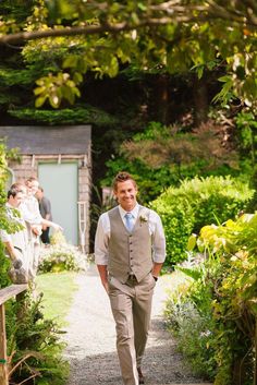 a man in a suit walking down a path