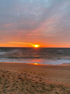 the sun is setting over the ocean with waves