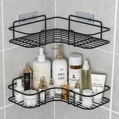 a bathroom shelf that has some bottles and soaps on it in front of a tiled wall