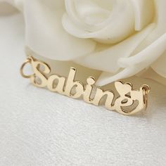 Stunning Solid 14k Yellow gold polished custom nameplates with a heart. We take our time with each nameplate to make it as perfect as possible. Perfect to wear everyday and in every occasion. Perfect gift for her Materials: 14k Gold Lenght: Aprox 1.5 Inches Thickness: 0.65mm Weight: 1.9 to 2.5 grams   Lenght: Aprox 40mm depending on the name. This numbers are just an estimate, it may vary depending the name. Add one of our beautiful 14k gold chains to go with your nameplate: https://www.etsy.com Hypoallergenic Gold Nameplate Jewelry, Customizable Yellow Gold Nameplate Jewelry, Valentine's Day Gold Plated Nameplate Jewelry, Customized Gold Heart Nameplate Necklace, Gold Polished Nameplate Jewelry, Solid Gold Jewelry, Gold Polish, Perfect Gift For Her, Name Plate