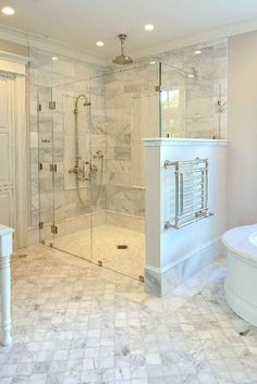 a large bathroom with a walk in shower next to a white sink and bathtub