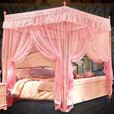 a pink canopy bed with curtains and pillows