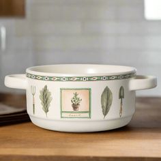 a white bowl sitting on top of a wooden table