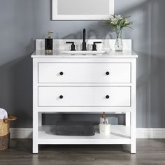 a bathroom vanity with two sinks and a mirror on the wall above it, along with a wicker basket