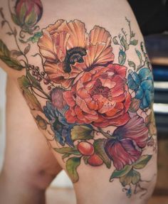 a woman's thigh with flowers on it