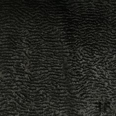 the texture of an animal fur is shown in black and grey tones, with small waves on it