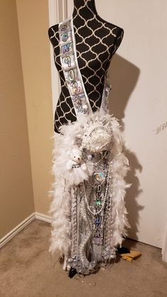 a mannequin is adorned with white feathers and sequins in the shape of an angel